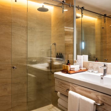 a bathroom with a glass shower and sink