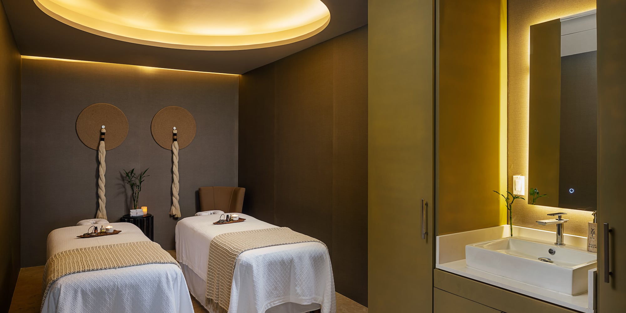 a room with two beds and a sink