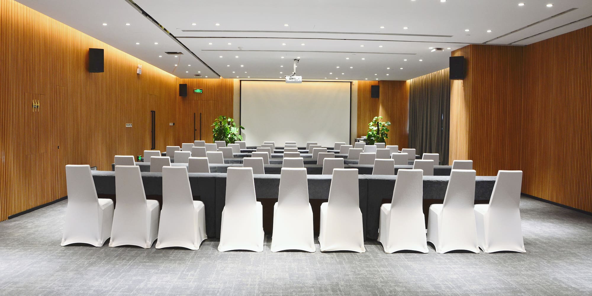 a room with chairs and a screen