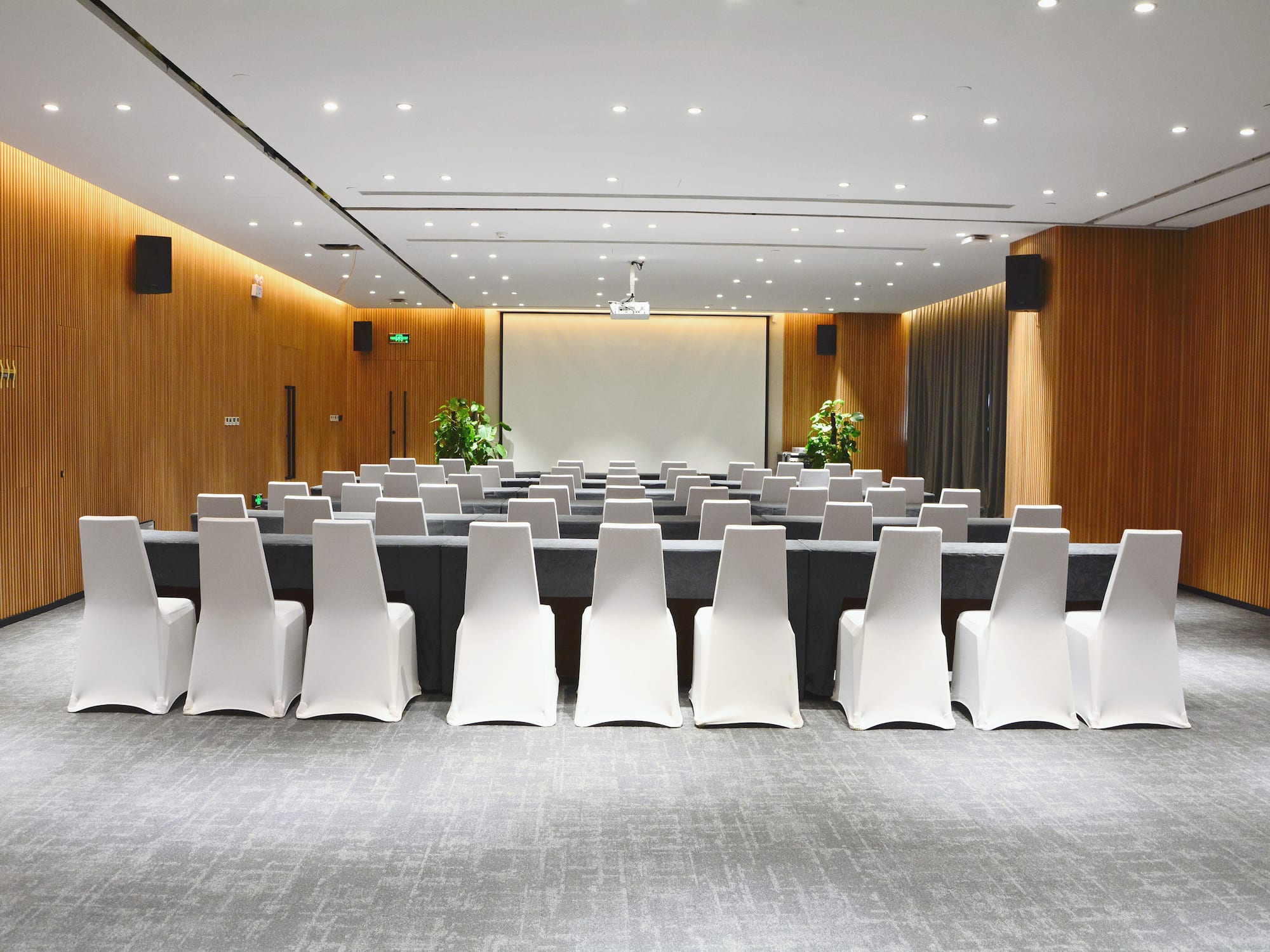 a room with chairs and a screen