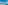 Aerial view of turquoise sea, sandy beach, coastal resort, mountains, and pier.