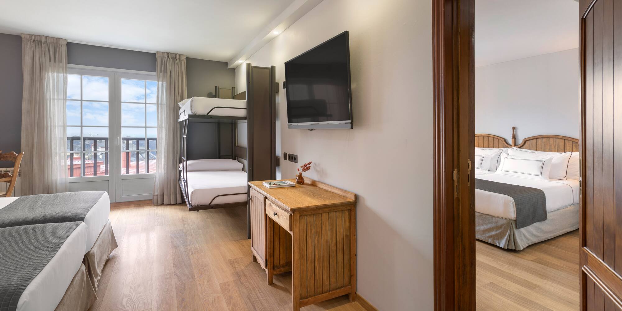 a room with a tv and bunk beds