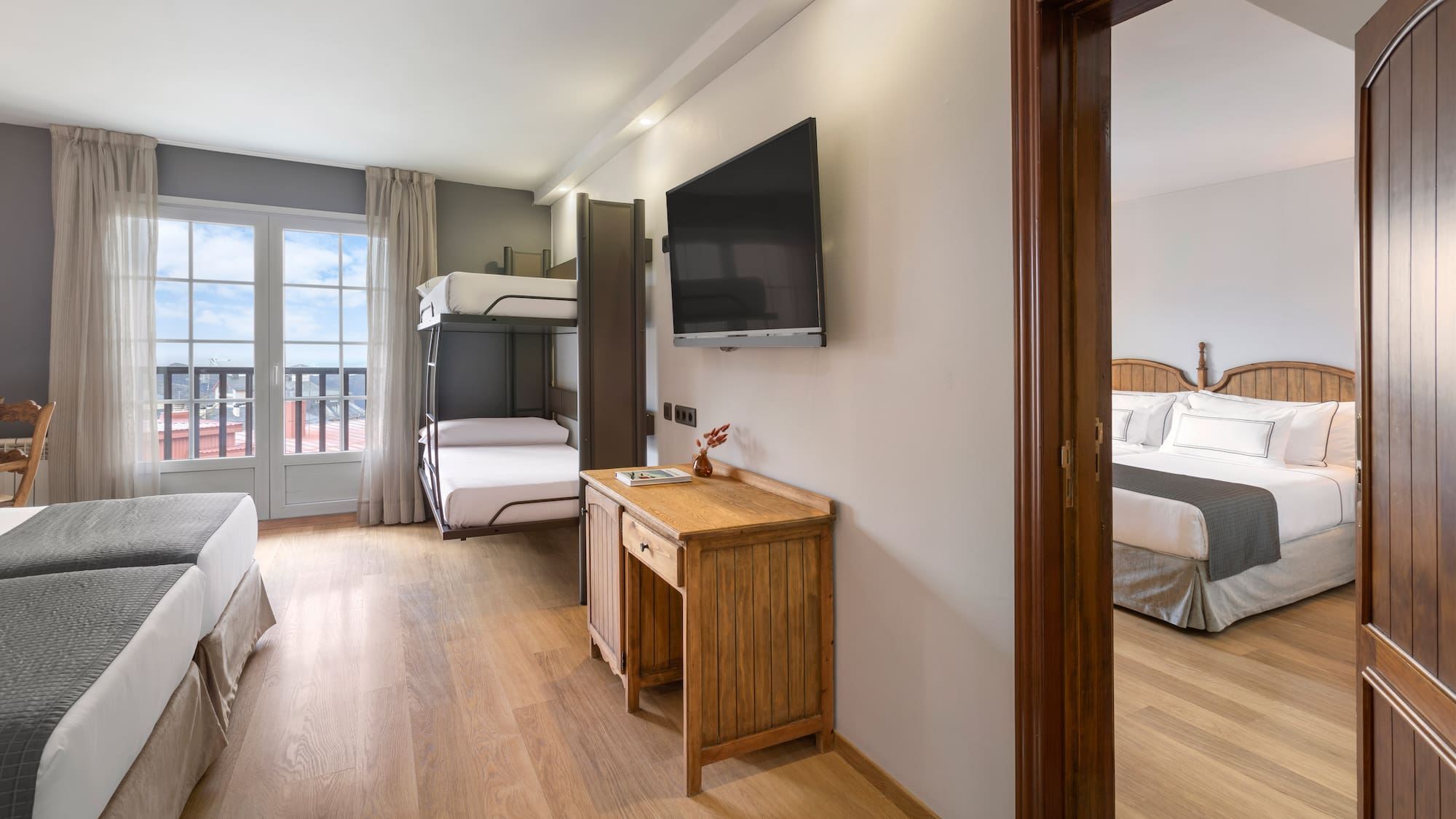 a room with a tv and bunk beds