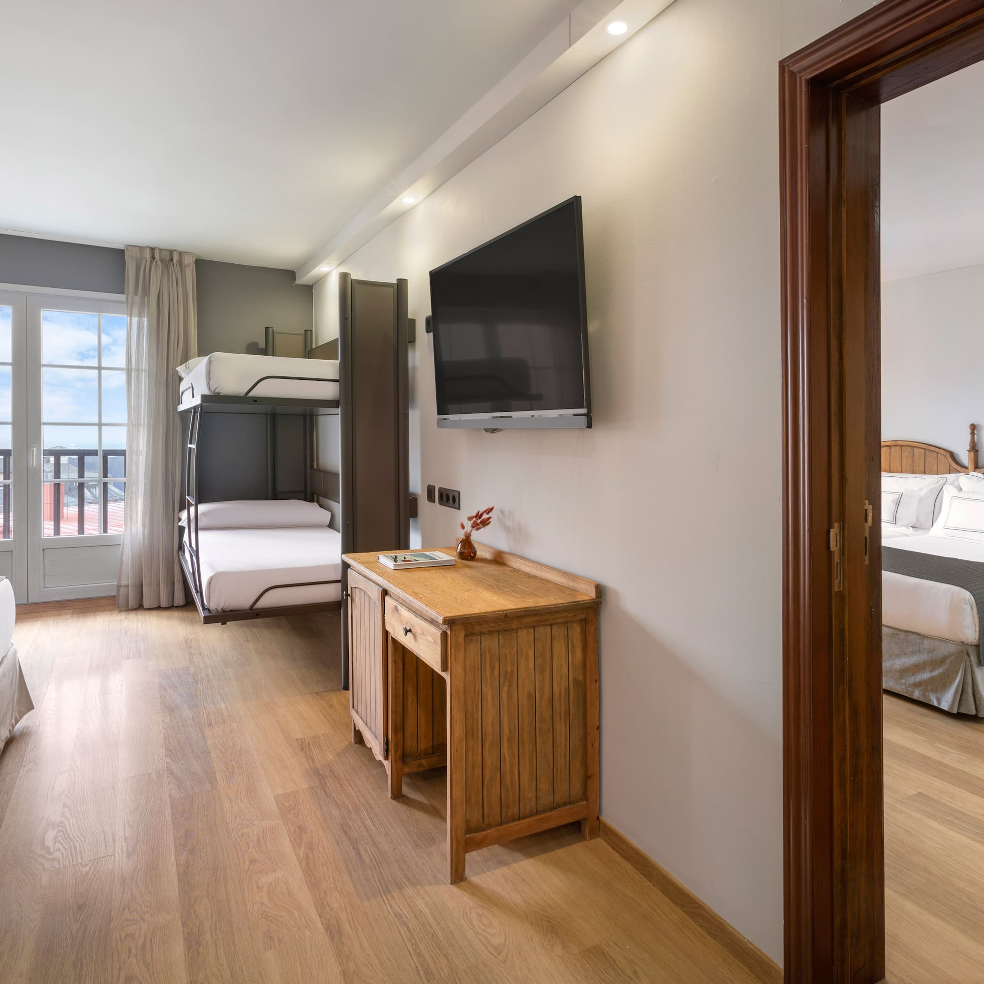 a room with a tv and bunk beds