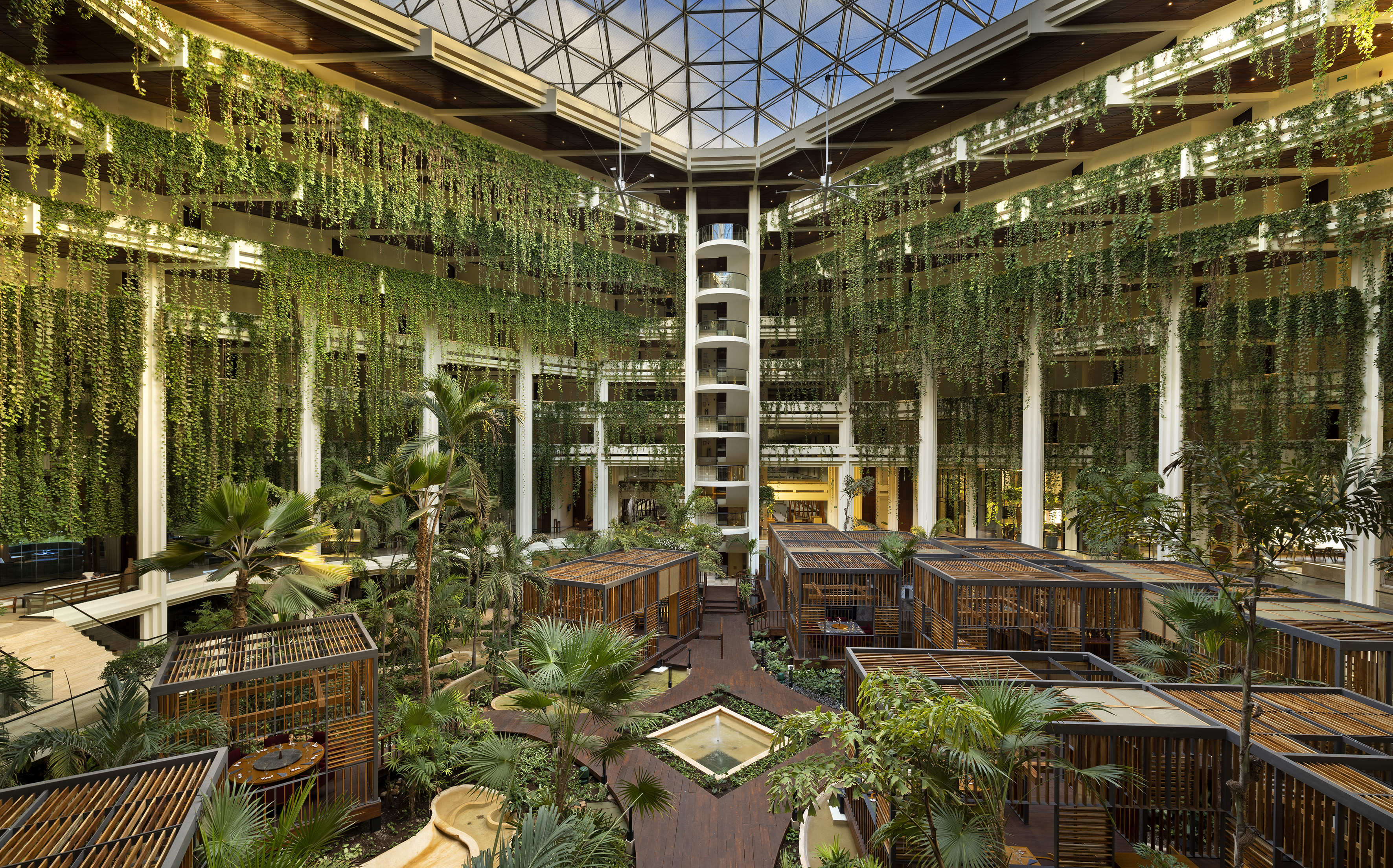 a building with many cages and plants