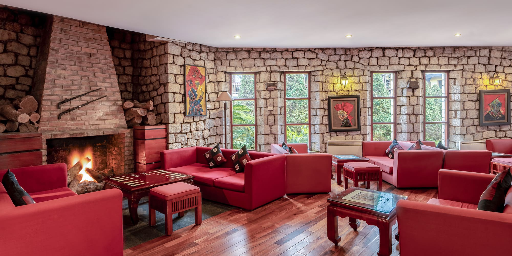 a room with red couches and a fireplace