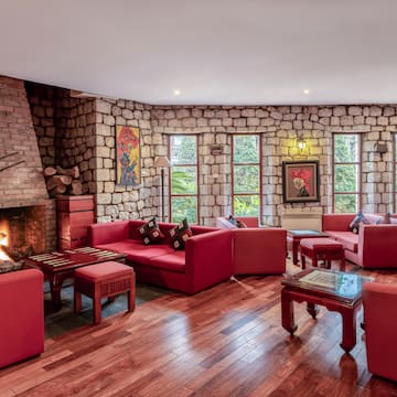 a room with red couches and a fireplace