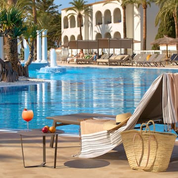 a pool with a chair and a table