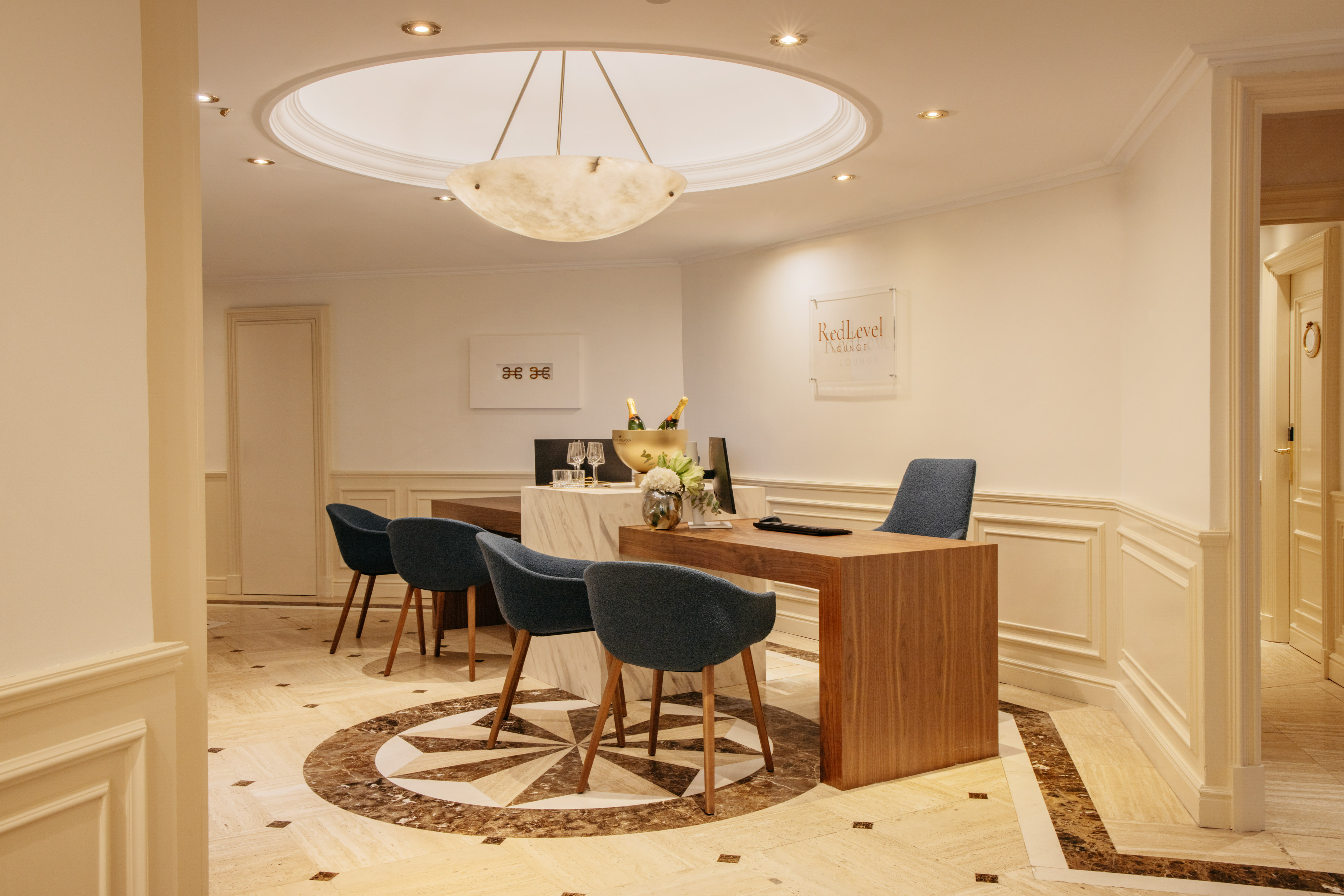 RedLevel luxury lounge reception with champagne service and marble floor.