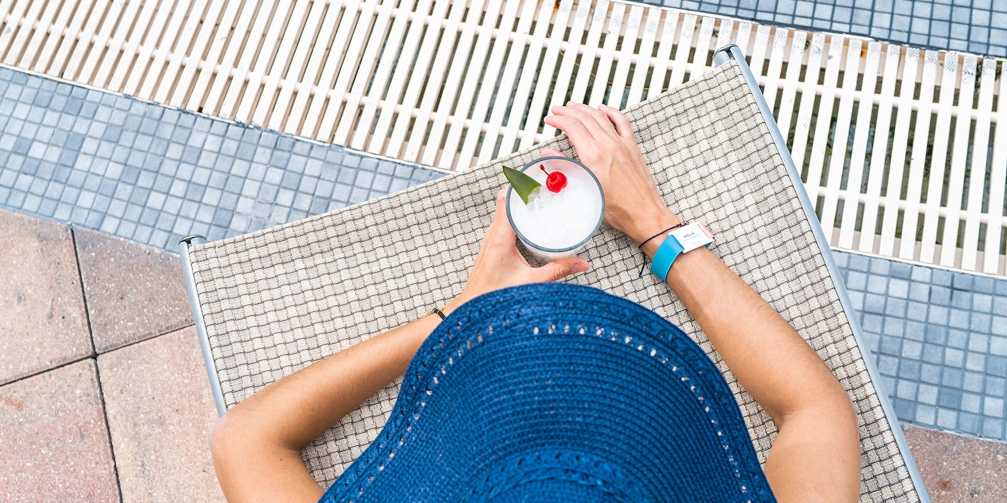 a person wearing a hat and holding a drink