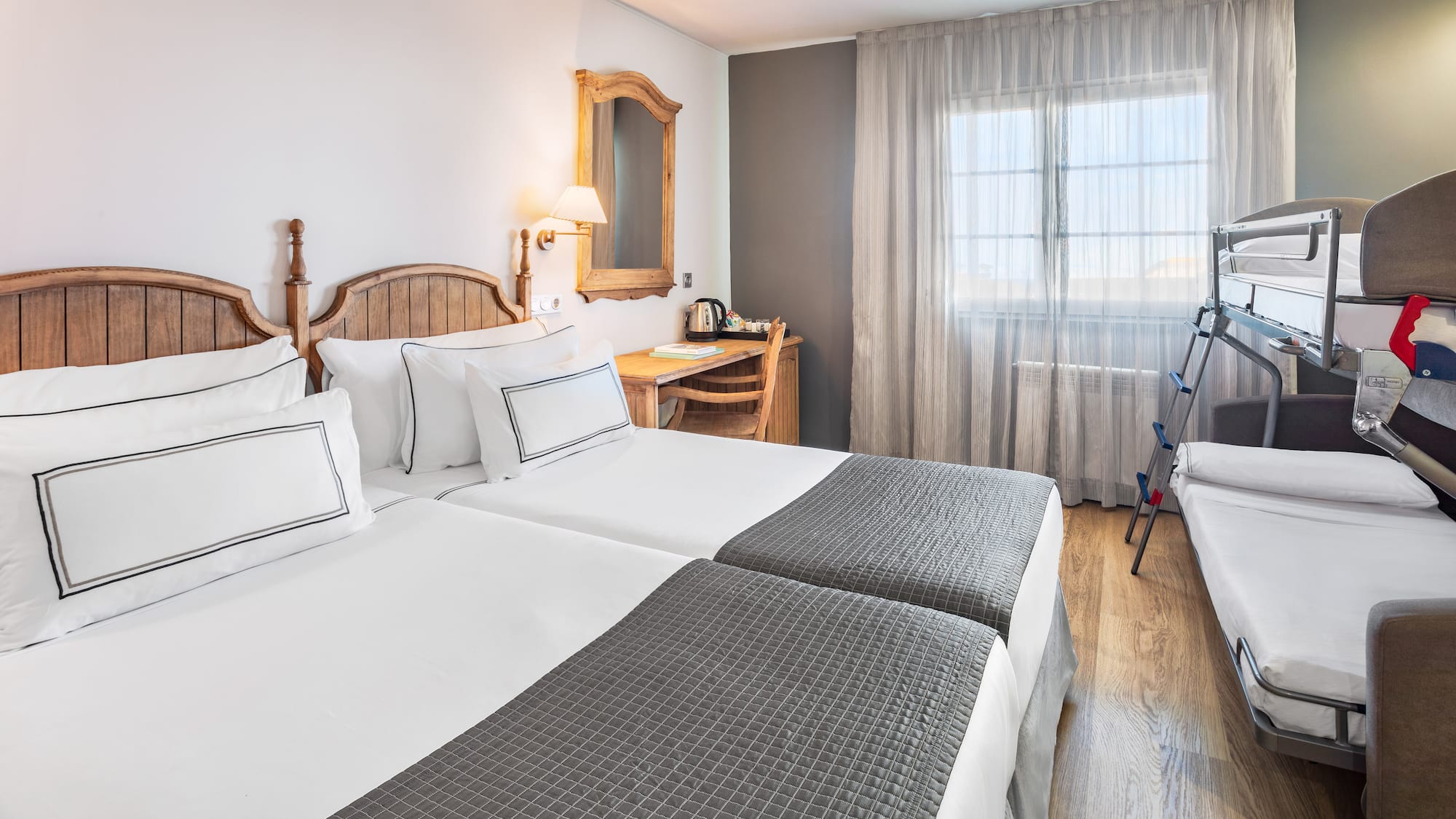 a room with two beds and a desk