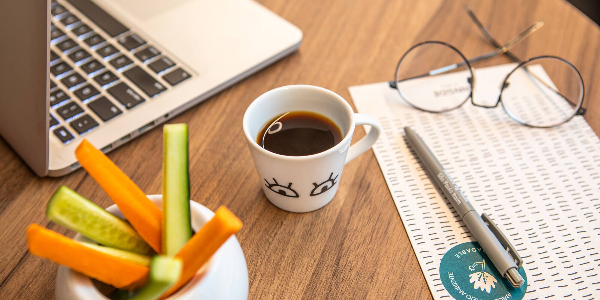 a cup of coffee and vegetables on a table