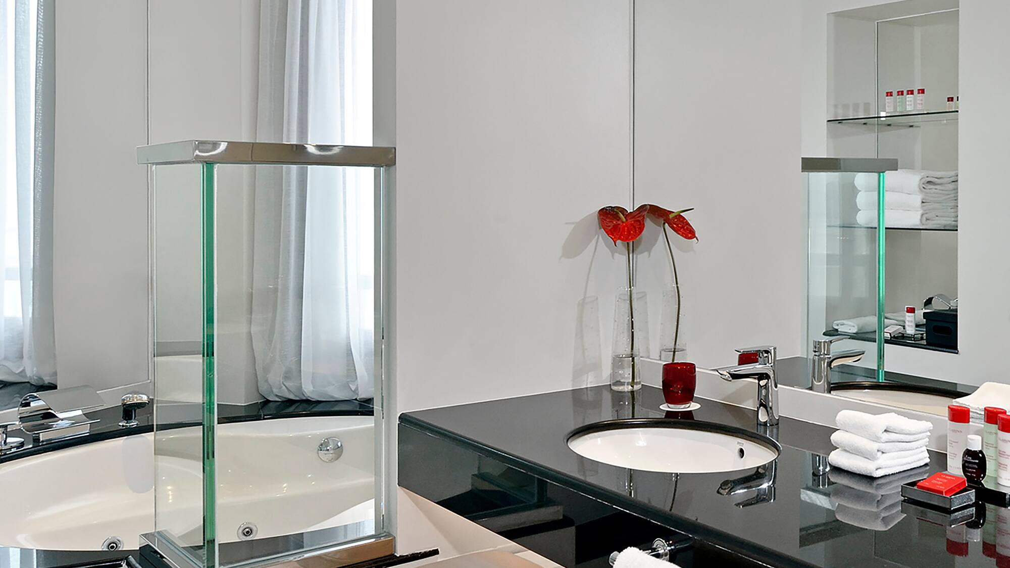 a bathroom with a black countertop and a tub