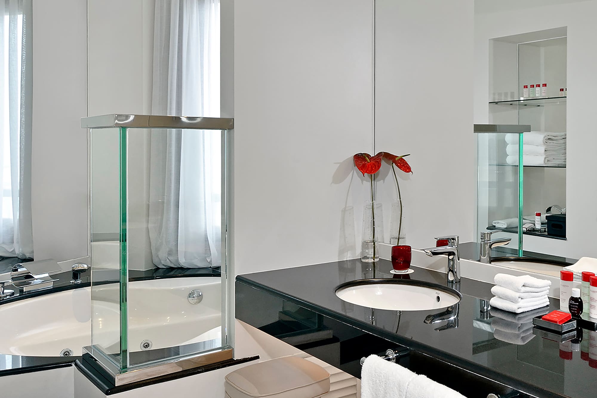 a bathroom with a black countertop and a tub