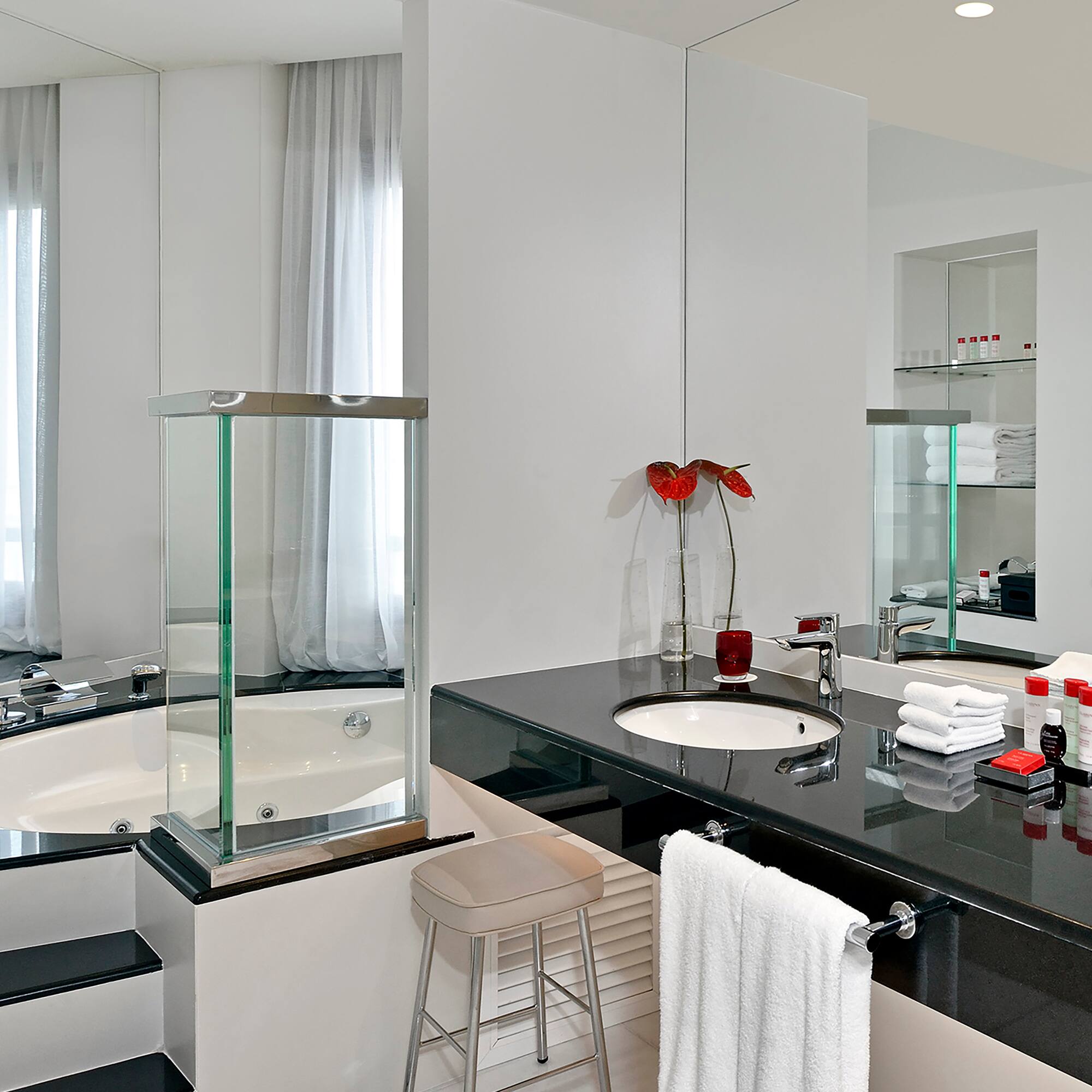 a bathroom with a black countertop and a tub