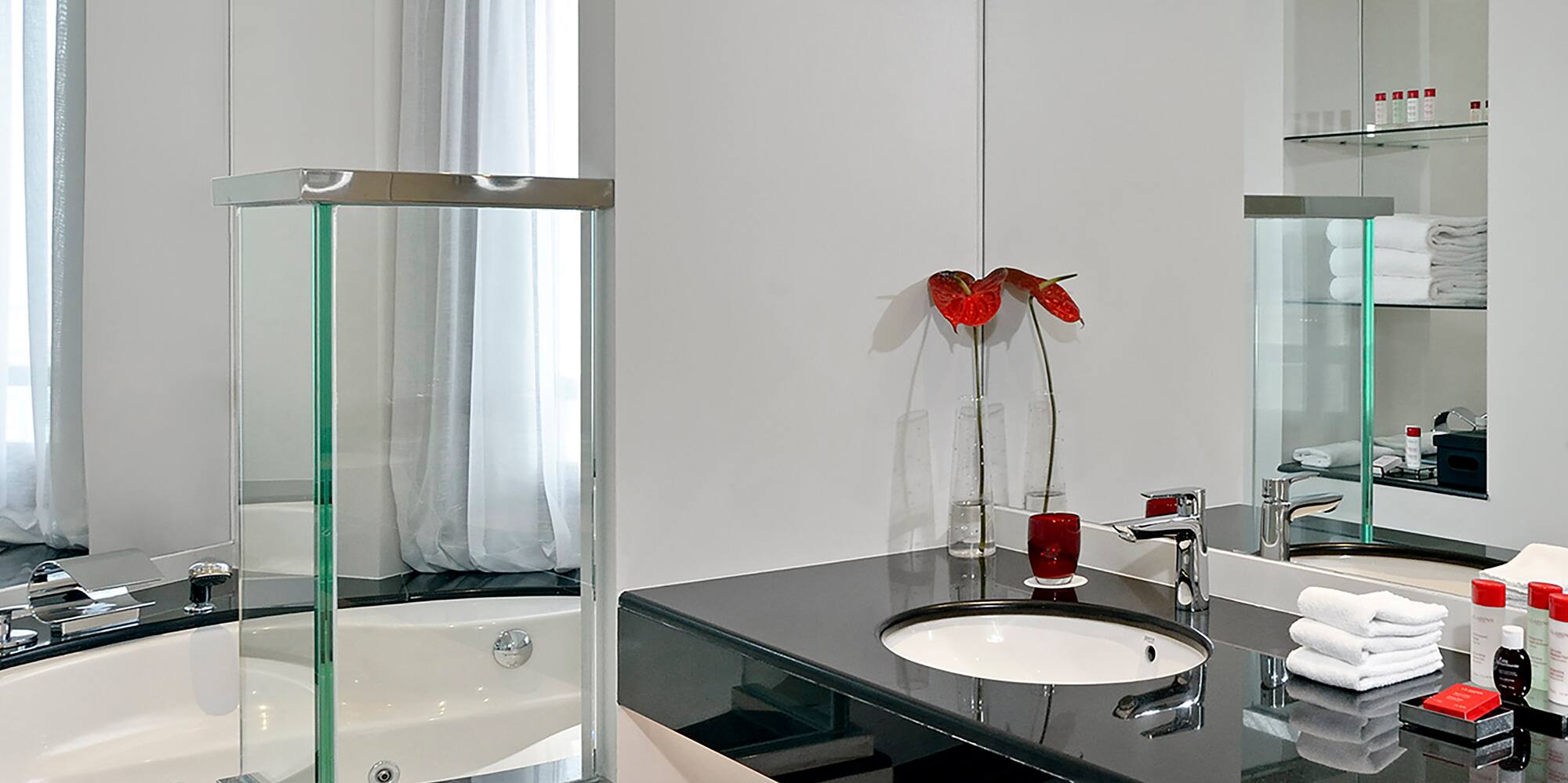 a bathroom with a black countertop and a tub