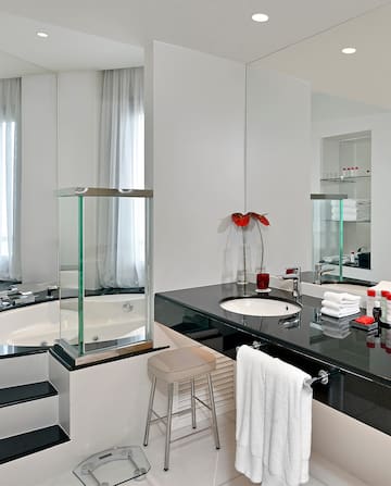 a bathroom with a black countertop and a tub