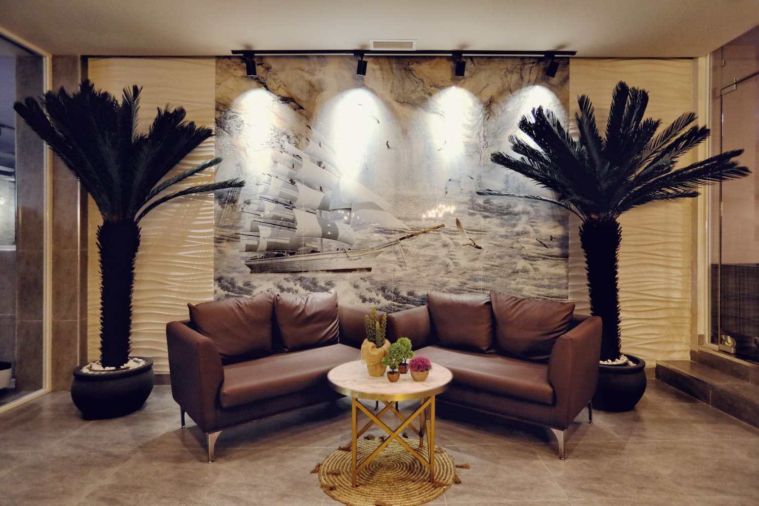 a room with couches and palm trees