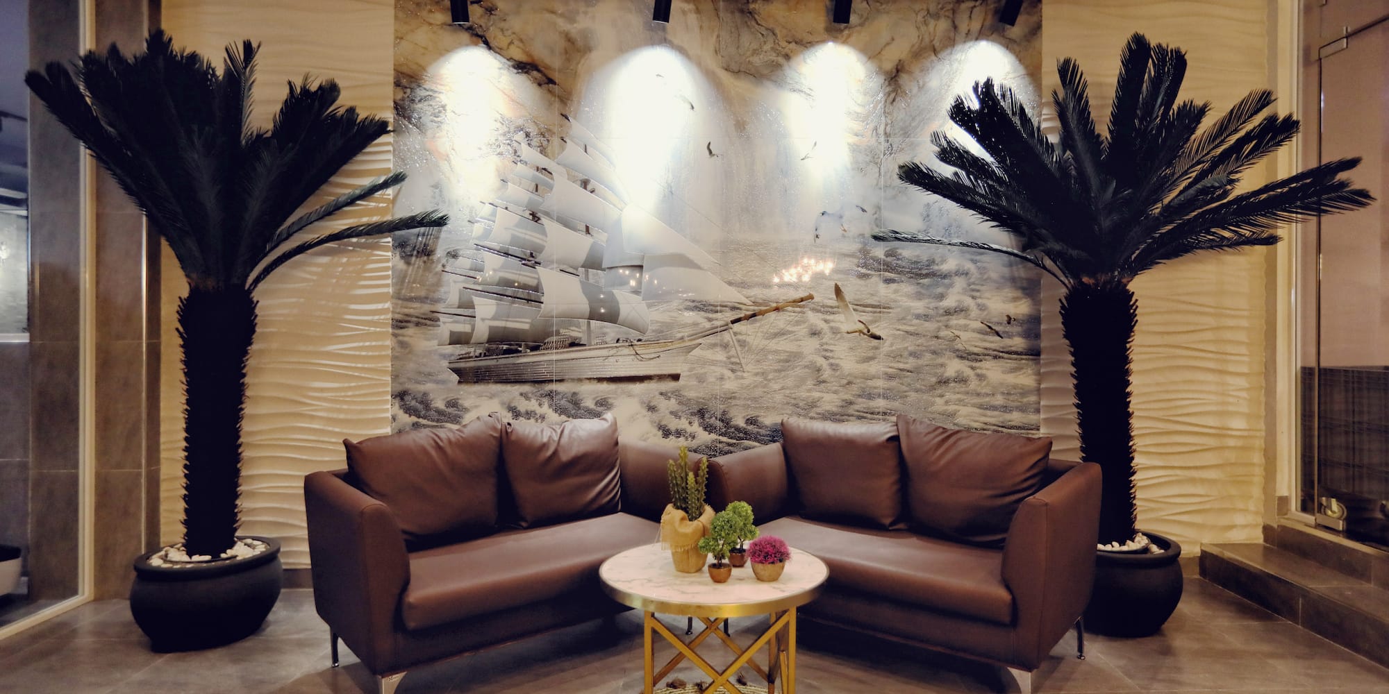 a room with couches and palm trees