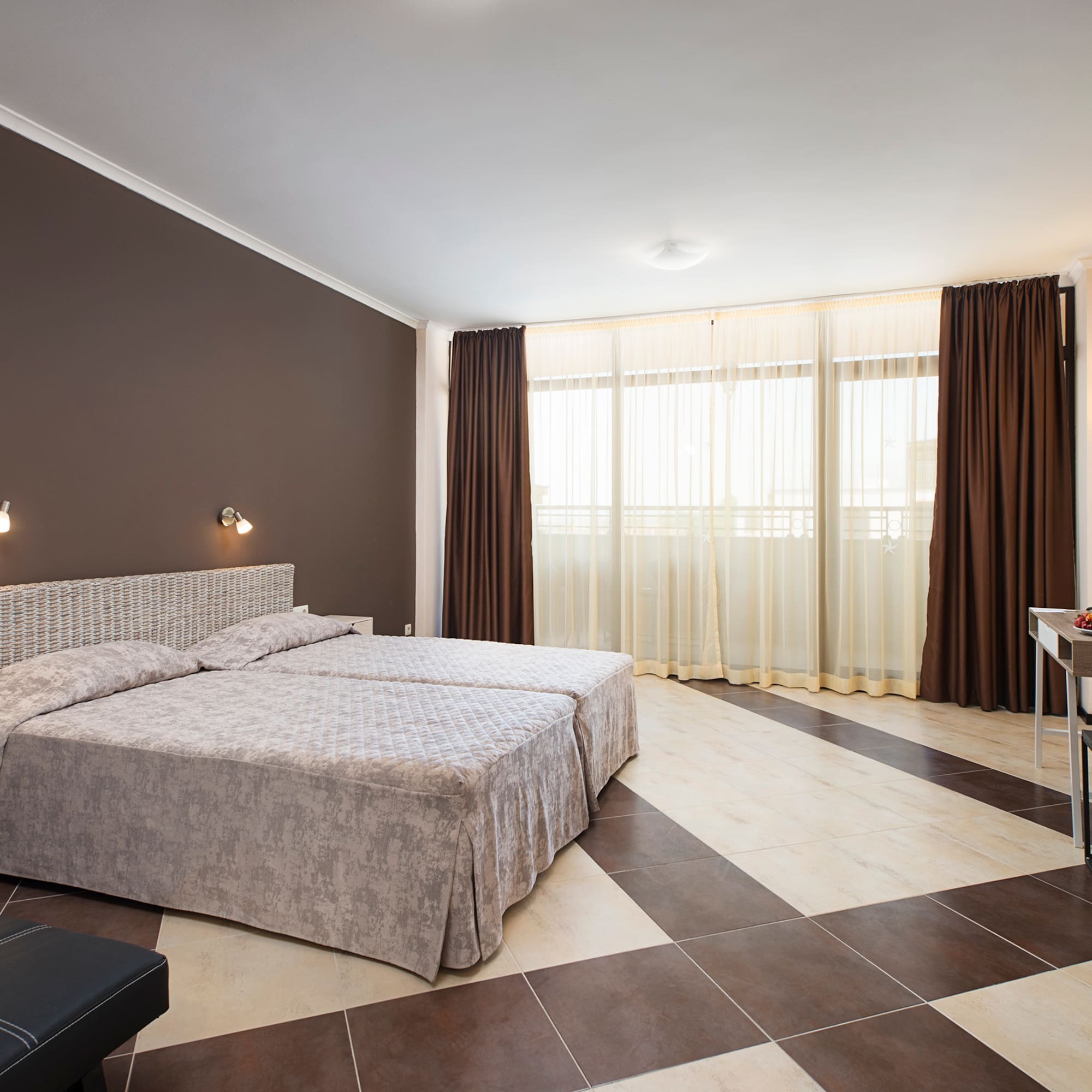 a bedroom with a checkered floor and a desk
