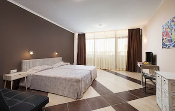 a bedroom with a checkered floor and a desk