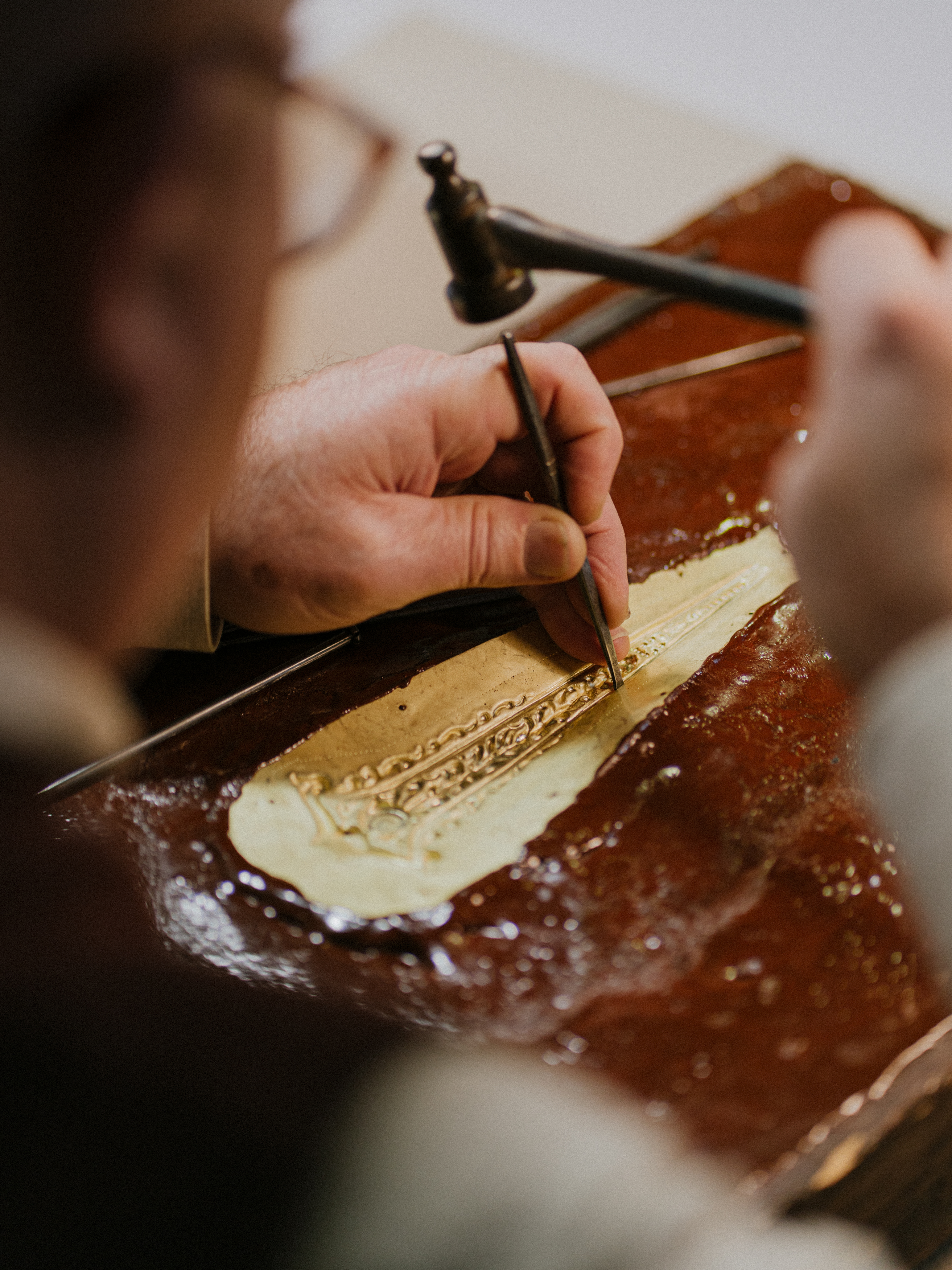 a person using a tool to make a piece of art