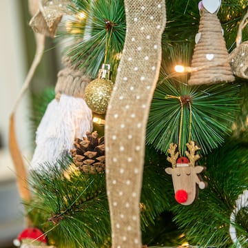 a christmas tree with ornaments and a ribbon