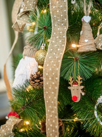 a christmas tree with ornaments and a ribbon