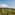 Helicopter flying over lush green vineyards in wine country.