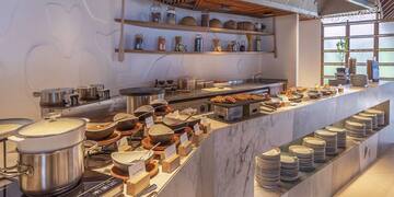 a buffet with plates and bowls on it