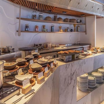 a buffet with plates and bowls on it