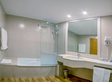a bathroom with a tub and a mirror