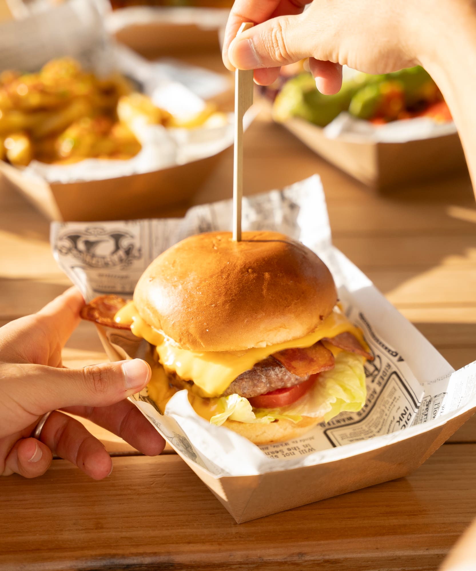 a person holding a burger