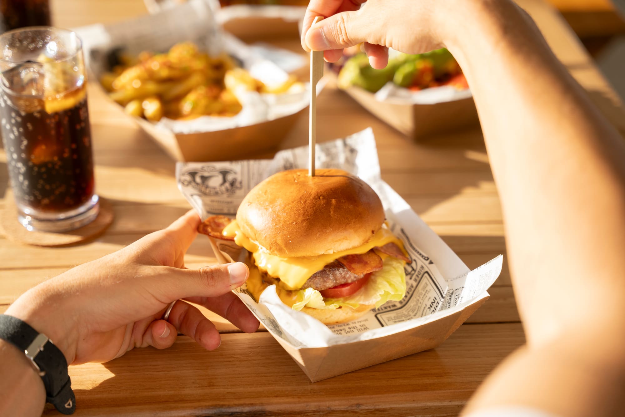 a person holding a burger
