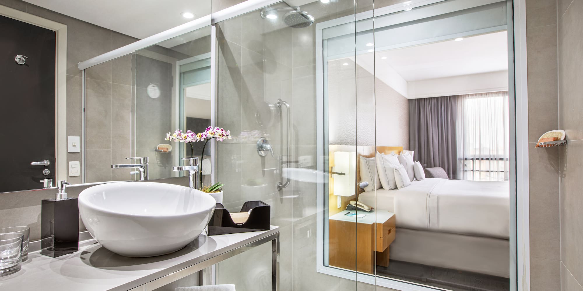 a bathroom with a glass shower and a sink