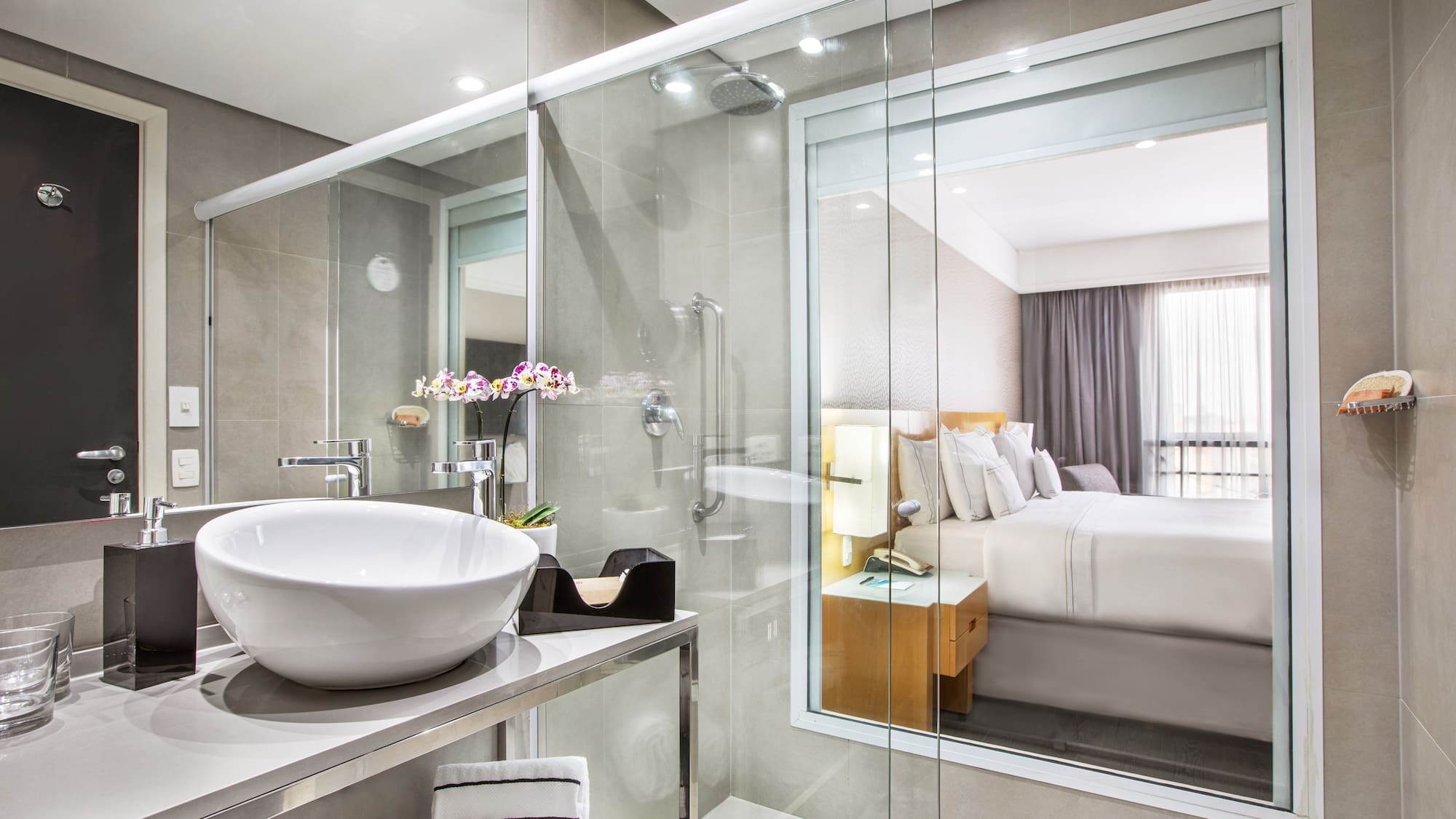 a bathroom with a glass shower and a sink