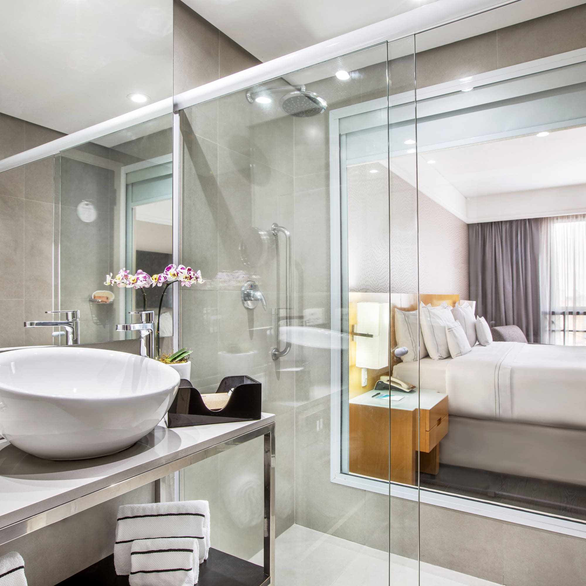 a bathroom with a glass shower and a sink