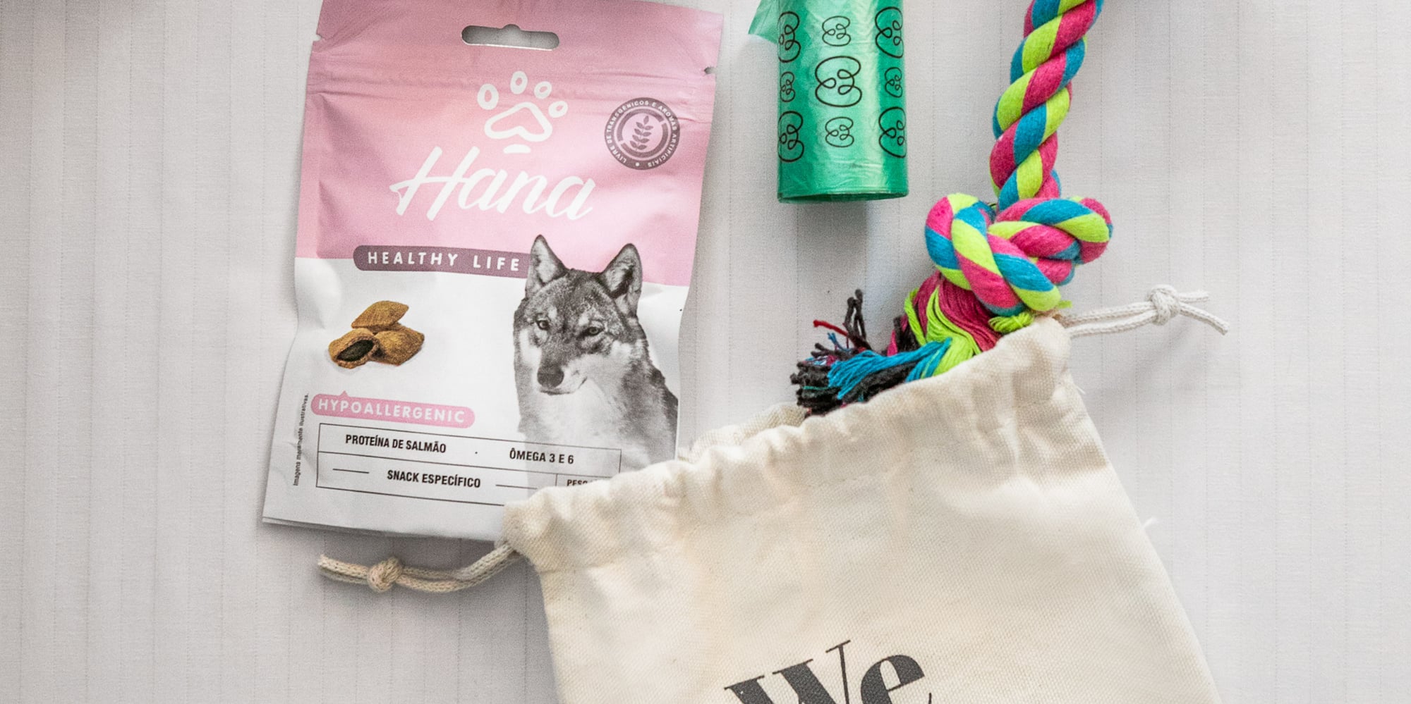 Meliã pet-friendly dog care package with food, colorful rope toy, and poop bags.