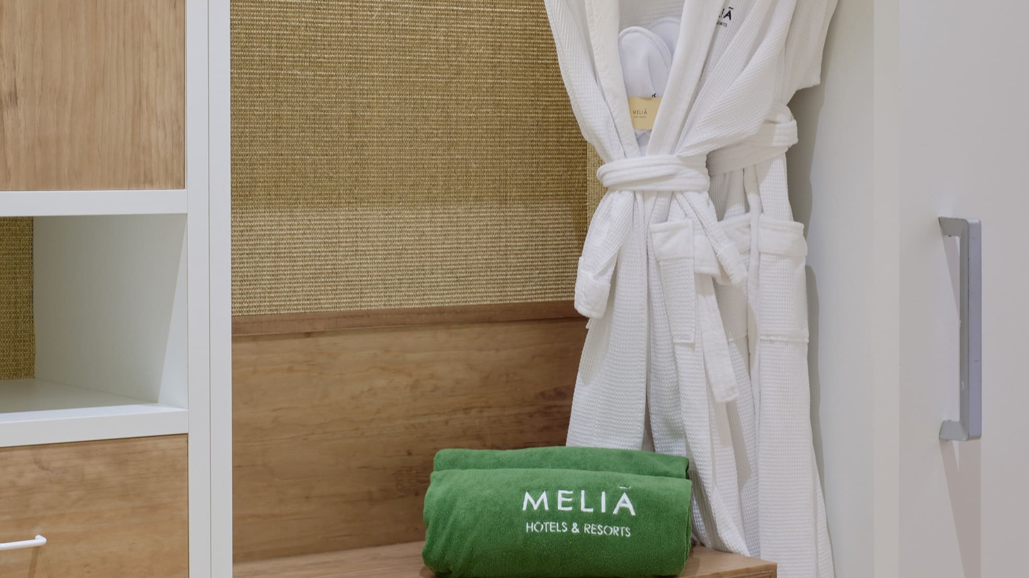 a white robe on a rack in a closet