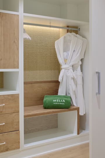 a white robe on a rack in a closet