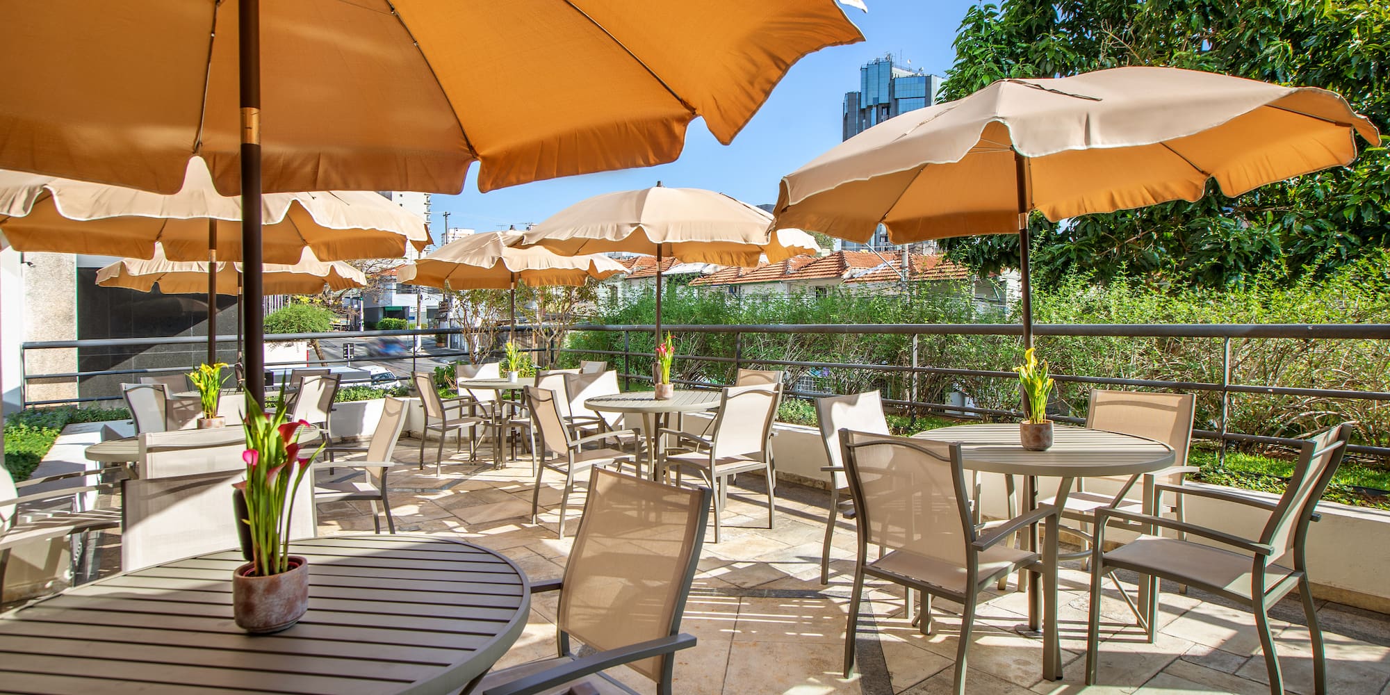 a patio with tables and umbrellas