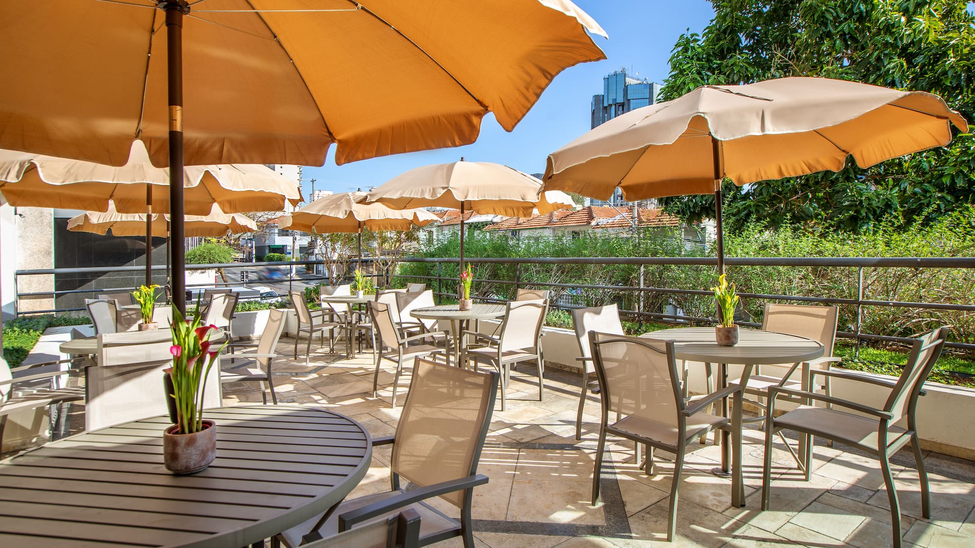 a patio with tables and umbrellas