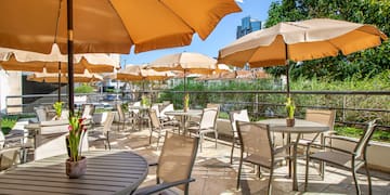 a patio with tables and umbrellas