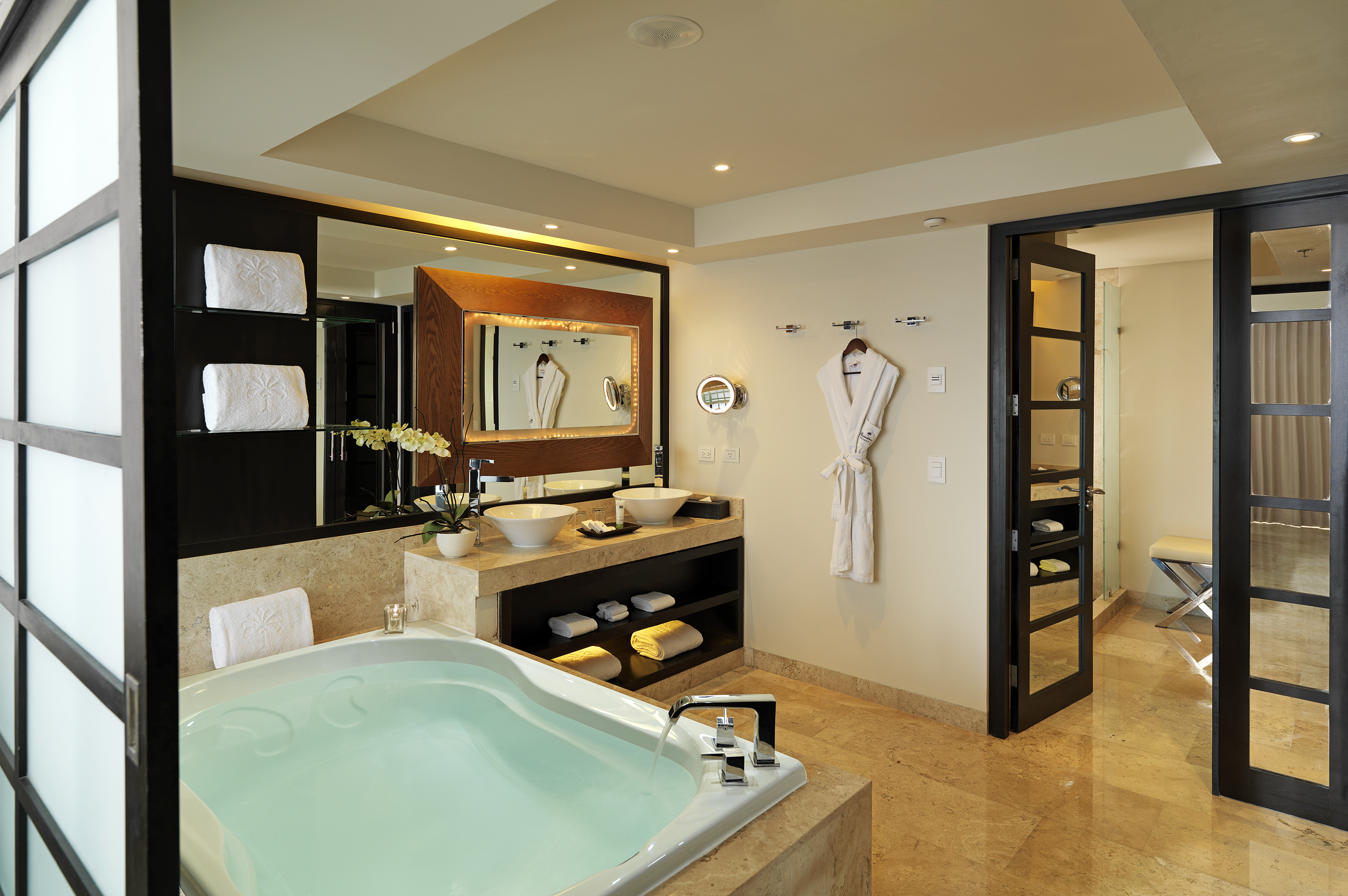 Spacious luxury bathroom with large soaking tub, double vanity, and elegant decor.