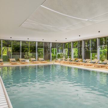 a pool with lounge chairs and a deck