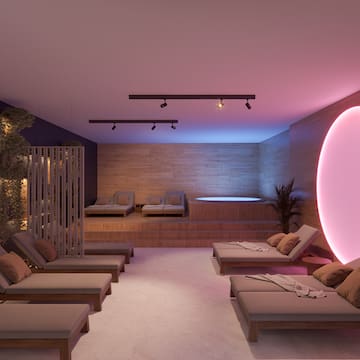 a room with lounge chairs and a hot tub