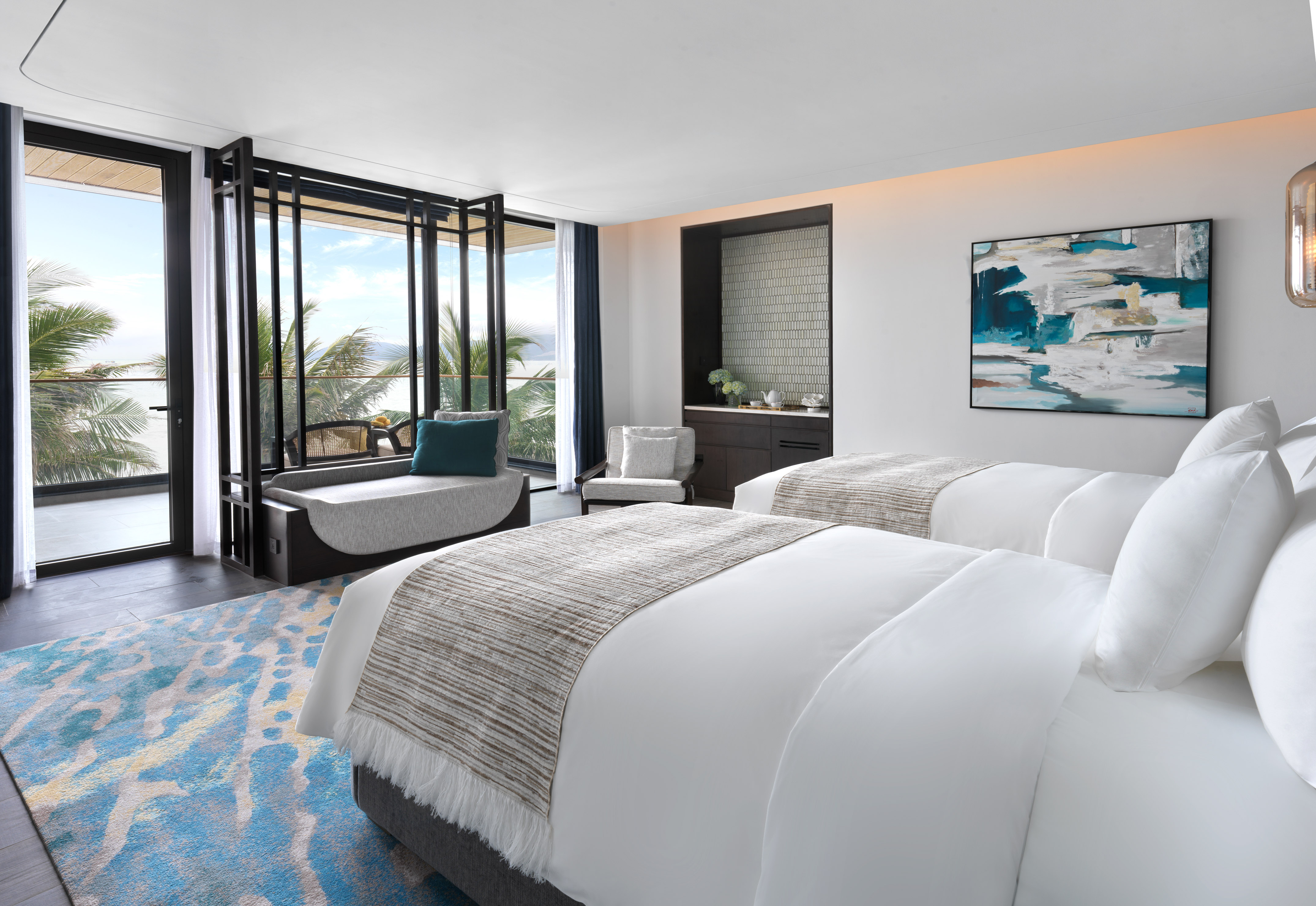 Luxury resort room with twin beds, ocean view, palm trees, and modern design.