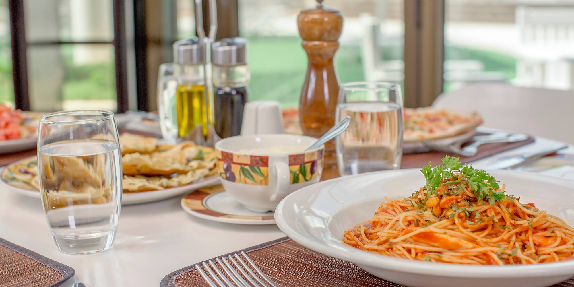 a plate of pasta and a fork on a table