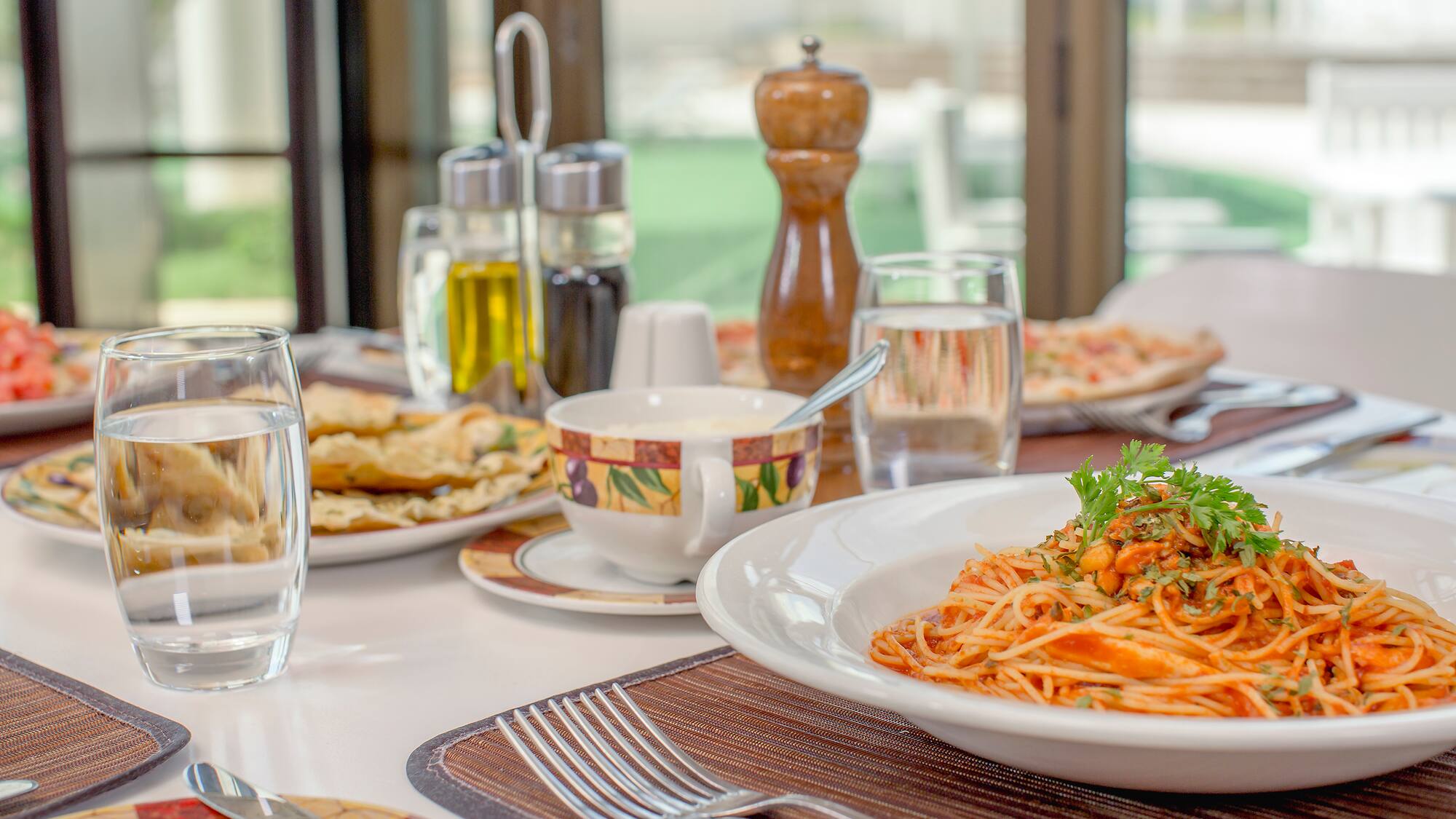 a plate of pasta and a fork on a table