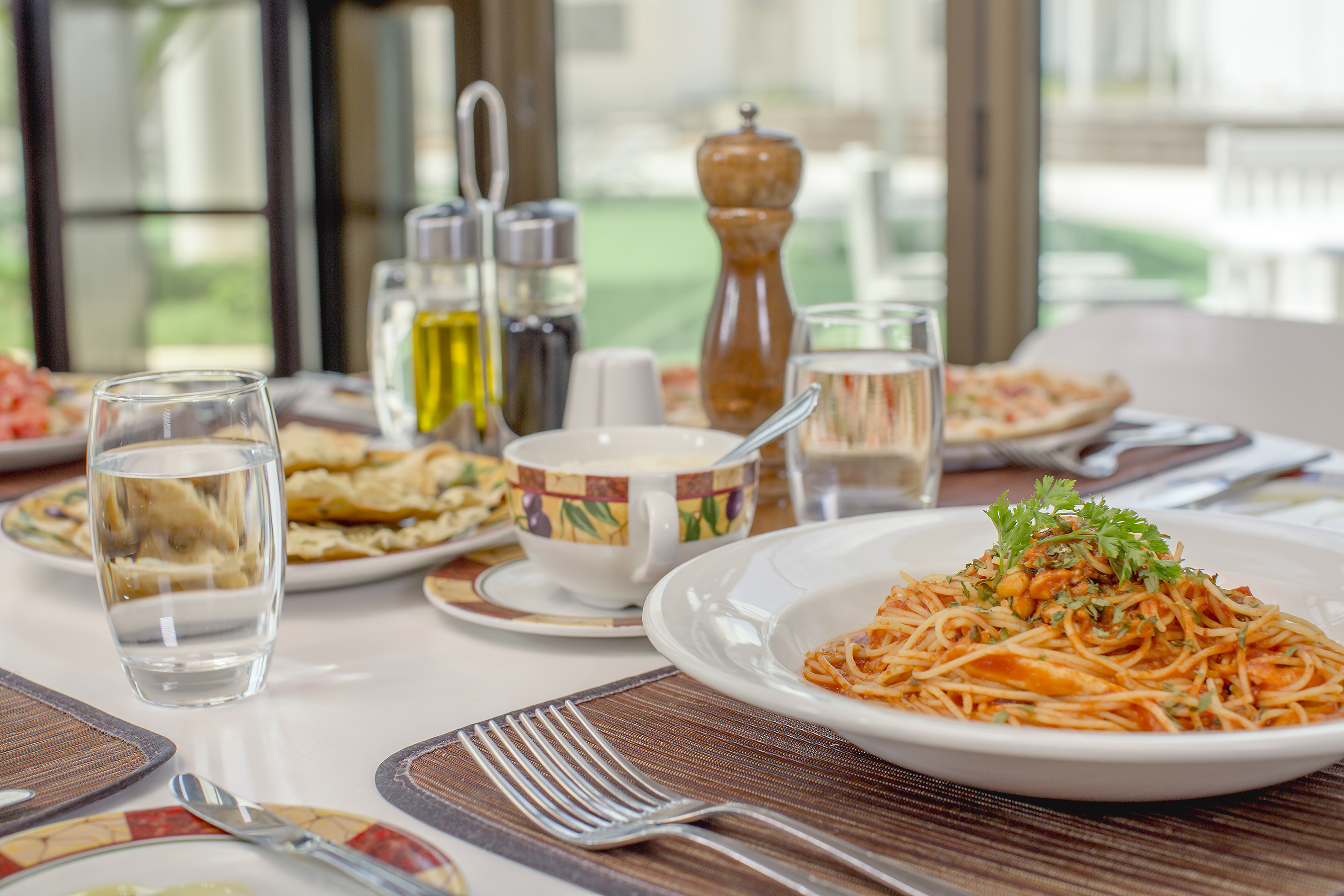 a plate of pasta and a fork on a table